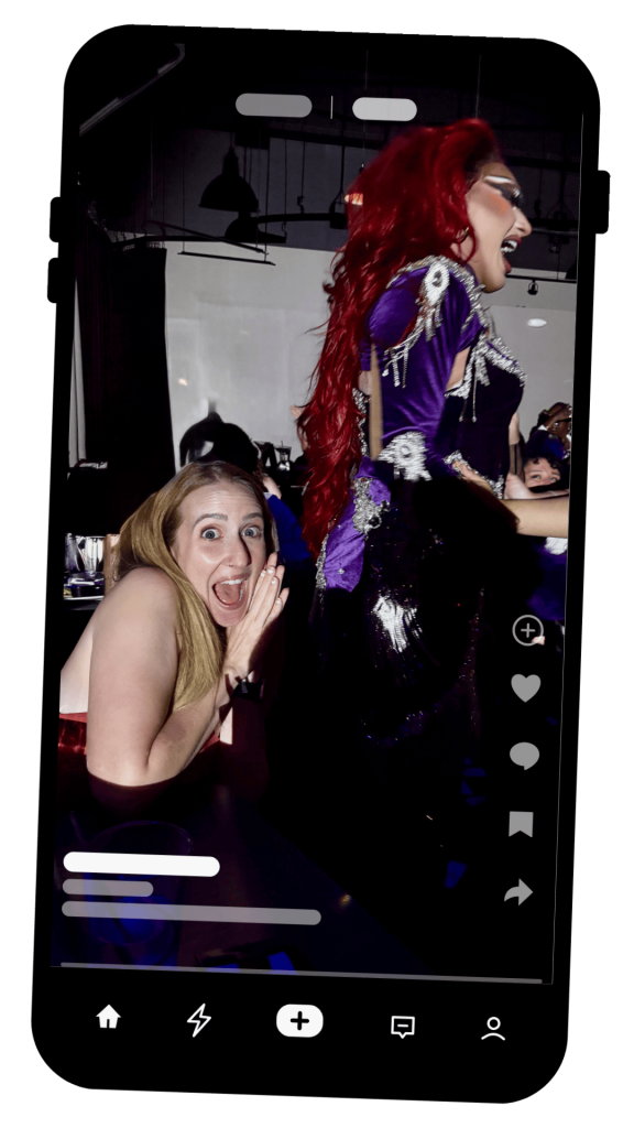 in image on an iphone of Hayley looking excited a mere inches away from Anetra from season 15 of RuPaul's Drag Race
